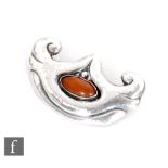 Unknown - A Danish silver brooch of shaped oval outline with scrolling borders in a planished