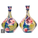 Charlotte Rhead - Bursley Ware - A pair of early 20th Century Seed Poppy pattern vases of globe