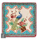 Longwy - An 8 inch teapot stand decorated with a peacock perched on a flowering branch within