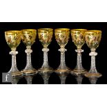 Moser - A set of six late 19th Century hock glasses, each with a green ovoid bowl heavily gilded