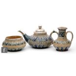 Francis E Lee - Doulton Lambeth - A late 19th Century conforming teapot, milk jug and sugar bowl