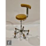 Unknown - A tan vinyl upholstered task or operator's swivel chair or stool, the chromium plated