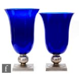 After Émile Jacques Ruhlmann - A pair of 1930s blue glass vases of trumpet form, mounted to a