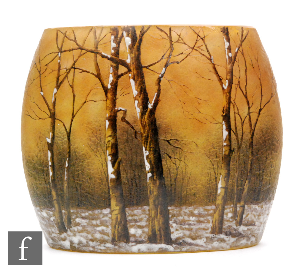 Daum - An early 20th Century cameo vase of compressed ovoid form cut with a winter woodland