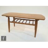 Unknown - An oak coffee table of rounded rectangular form, raised to tapered legs united by a