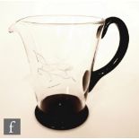 Vicke Lindstrand - Orrefors - A 1930s clear crystal jug of conical form with applied onyx foot and