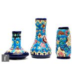 Longwy - Three miniature vases of varying form decorated with stylised flowers and foliage against