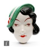 Attributed to Royal Dux - A small 1930s face mask modelled as a young lady with curled black hair