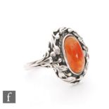 Unknown - An Arts and Crafts silver ring with central chalcedony cabochon in an oval border of