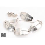 Georg Jensen - A suite of 1970s Danish jewellery comprising a four panel Sterling silver bracelet,