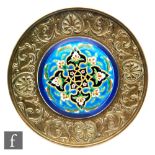 Longwy - A framed roundel, the domed shape with Persian type decoration within a blue border set
