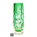 Pavel Hlava - Novy Bor - A 1960s glass vase of sleeve form, green cased in clear and relief