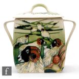 Philip Gibson - Moorcroft Pottery - A twin handled square biscuit box and cover decorated in the