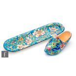 Longwy - A rounded rectangular pen tray decorated with stylised flowers against a blue ground,