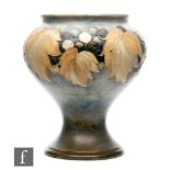 William Moorcroft - A vase of footed inverted baluster form decorated in the salt glazed Leaf and
