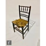 Morris & Co - A Sussex chair with ebonised frame and rush seat, height 83cm, S/D.