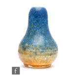 Ruskin Pottery - A miniature vase of globe and shaft form decorated in a blue to orange