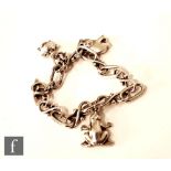 Georg Jensen - A Danish Sterling silver charm bracelet with three charms comprising an elephant, a