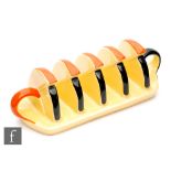 Carlton Ware - A 1930s Art Deco toast rack in yellow with orange and black painted detailing,