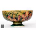 William Moorcroft - A Spanish pattern footed bowl decorated to the exterior with tubelined flowers