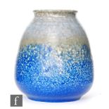 Ruskin Pottery - A vase of tapering form decorated with an upper souffle glaze band in tones of