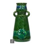 Burmantofts Faience - A late 19th Century tri handled vase decorated in an all over green glaze with