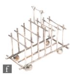 In the manner of Christopher Dresser for Hukin & Heath - A silver plated six division toast rack