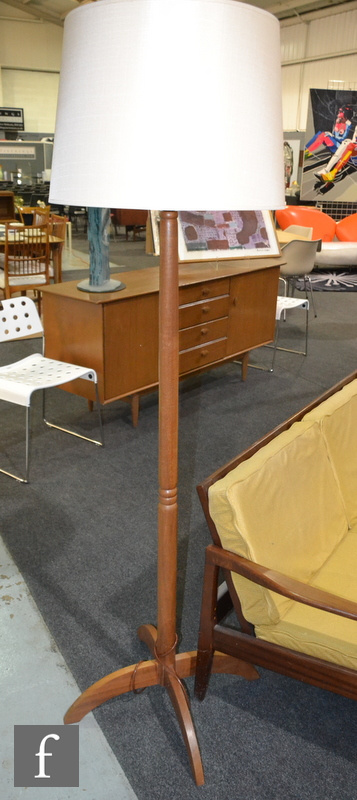 Unknown - A teak floor lamp raised to a cruciform base, height 134cm (excluding the bulb fittings).