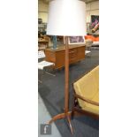 Unknown - A teak floor lamp raised to a cruciform base, height 134cm (excluding the bulb fittings).