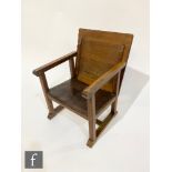 Unknown ? An Arts and Crafts oak metamorphic monks chair with leather seat folding into a table,