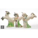 Clarice Cliff - Spring Lambs - A set of three leaping lamb figures with flowers and grasses picked