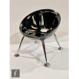 Unknown - A black lounge chair of moulded dished form raised to four splayed tapered chromium plated