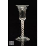 An 18th Century drinking glass circa 1770, bell form bowl above a double series opaque twist stem