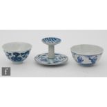 Two Chinese blue and white bowls, the first of 'U' form, adorned with rockwork and buddhistic