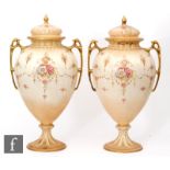 A pair of large early 20th Century Crown Devon Fieldings pedestal vases and covers decorated with