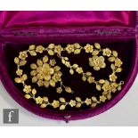 An early 20th Century silver gilt filagree necklet decorated with alternating flower heads and