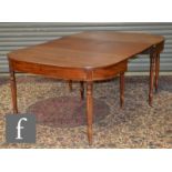 A George IV mahogany extending dining table of rounded rectangular form, with twin end sections
