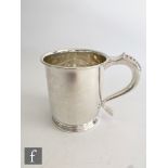 A hallmarked silver pint tankard of plain form terminating in scroll handle with beaded detail,
