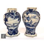 A pair of late 18th to early 19th Century hand painted Delft vases of compressed baluster form,