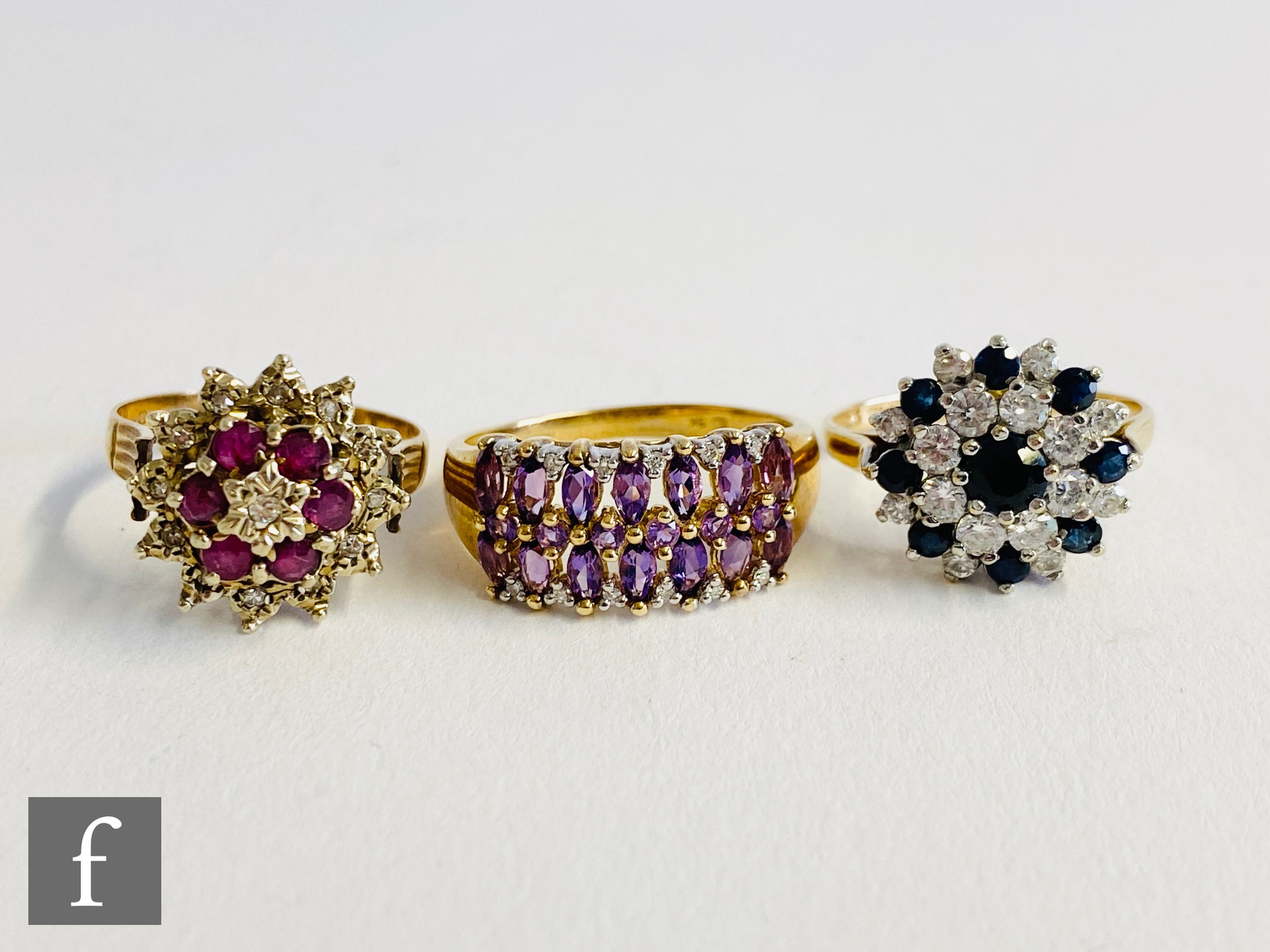 Three 9ct hallmarked stone set rings, sapphire, ruby and amethyst examples, total weight 10g. (3).