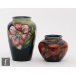 Two Moorcroft vases, the first decorated in the Pomegranate pattern with a band of whole and open