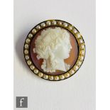 A 19th Century 15ct circular hardstone cameo profile of a Classical woman within a split pearl and