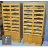 A pair of mid 20th Century haberdashery cabinets, each fitted with sixteeen glazed fronted drawers