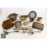 A parcel lot of assorted hallmarked silver items to include a sauce boat, two cigarette cases, and