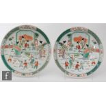 A pair of Chinese famille verte chargers, each of rounded form the field of each painted with