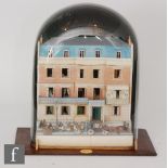 A Victorian style model of an 1880 town house constructed of paper under a glass dome with book,