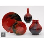 Four pieces of assorted Royal Doulton Flambe comprising two shallow dishes, shape 1621 and 1629, a