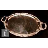A WMF silver plated twin handled oval tray of plain form with fruiting vine border and leaf capped