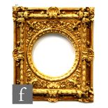 A mid 20th century carved and gilded Florentine style picture frame with scallop and scrolling