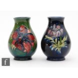 Two miniature Moorcroft vases, both of baluster form decorated in the Anemone pattern, one against a